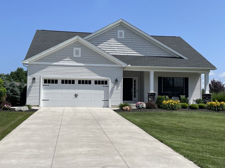 9105 W 88th Ave, Arvada, CO — Light gray two-story with a covered porch and mature landscaping