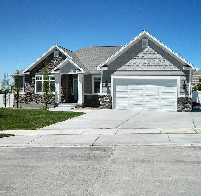 7680 E Quincy Ave, Denver, CO — Stone-accented ranch with an open kitchen and attached garage
